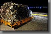 Luggage sits on pallets waiting to be loaded onto the planes